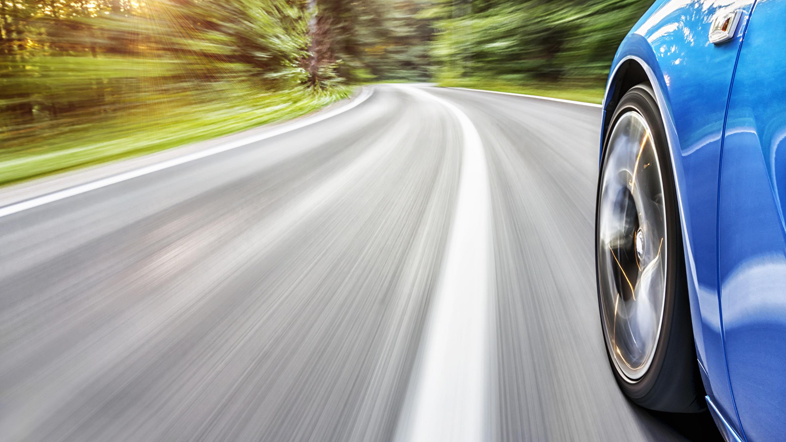 Voiture bleue roulant sur l'autoroute.